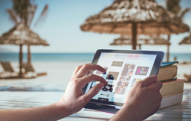 tablet on the beach - something that all travel bloggers do