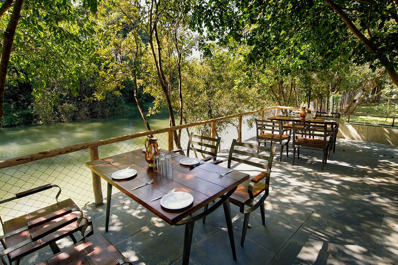 Resorts in Mulshi With Activities: dreamy cottages on an island outside dining view
